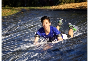 Mic (Roncalli College) going down the water slide after the School's Cross Country event.